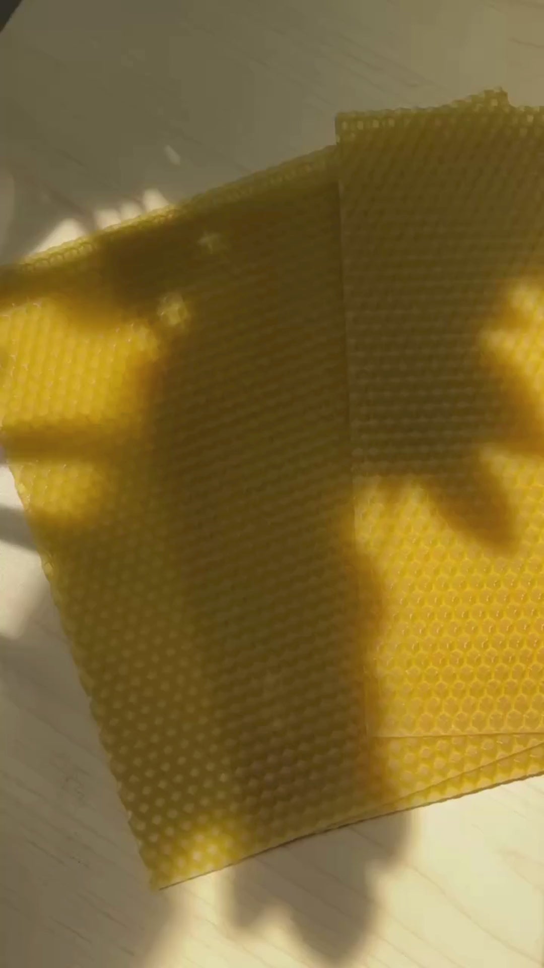 Natural beeswax sheets showing texture and flexibility in soft natural light

